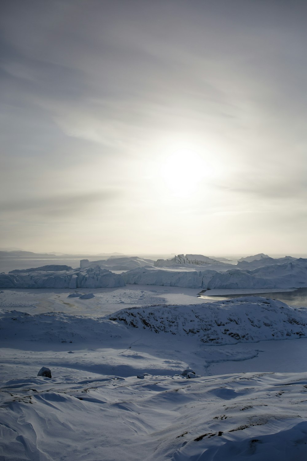 snow covered mountains under cloudy sky during daytime