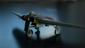 A detailed blueprint of a WWII fighter plane with dark industrial background.