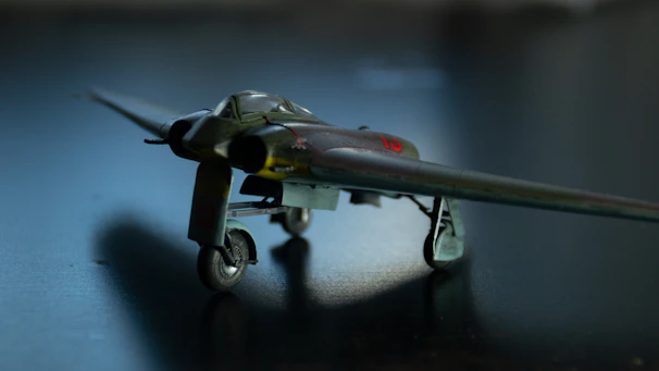 A detailed blueprint of a WWII fighter plane with dark industrial background.