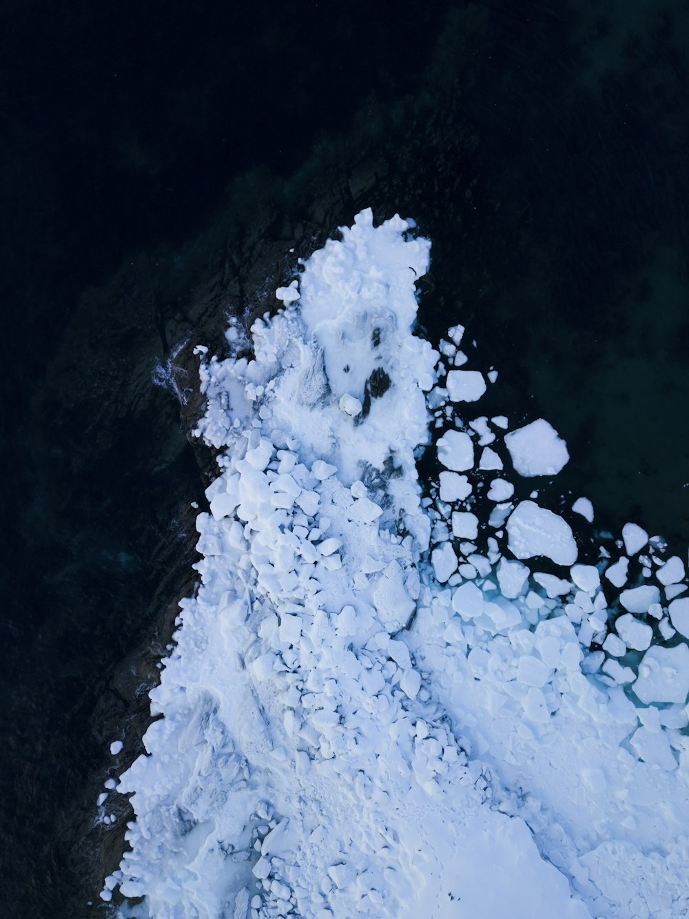 white snow on black surface