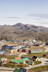 Colorful Andean village with traditional houses and mountainous backdrop.