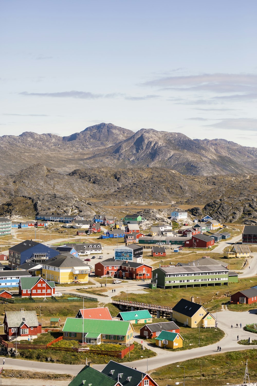 houses near mountain under white sky during daytime