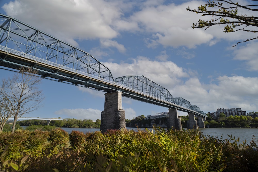 gray metal bridge under cloudy sky during daytime