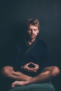Focused trader meditating before market opens at dawn.