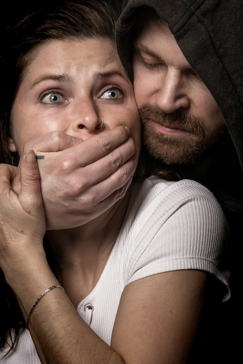 man apprehending woman in white tank top