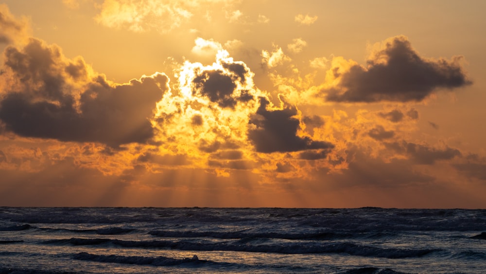 sea waves under cloudy sky during daytime