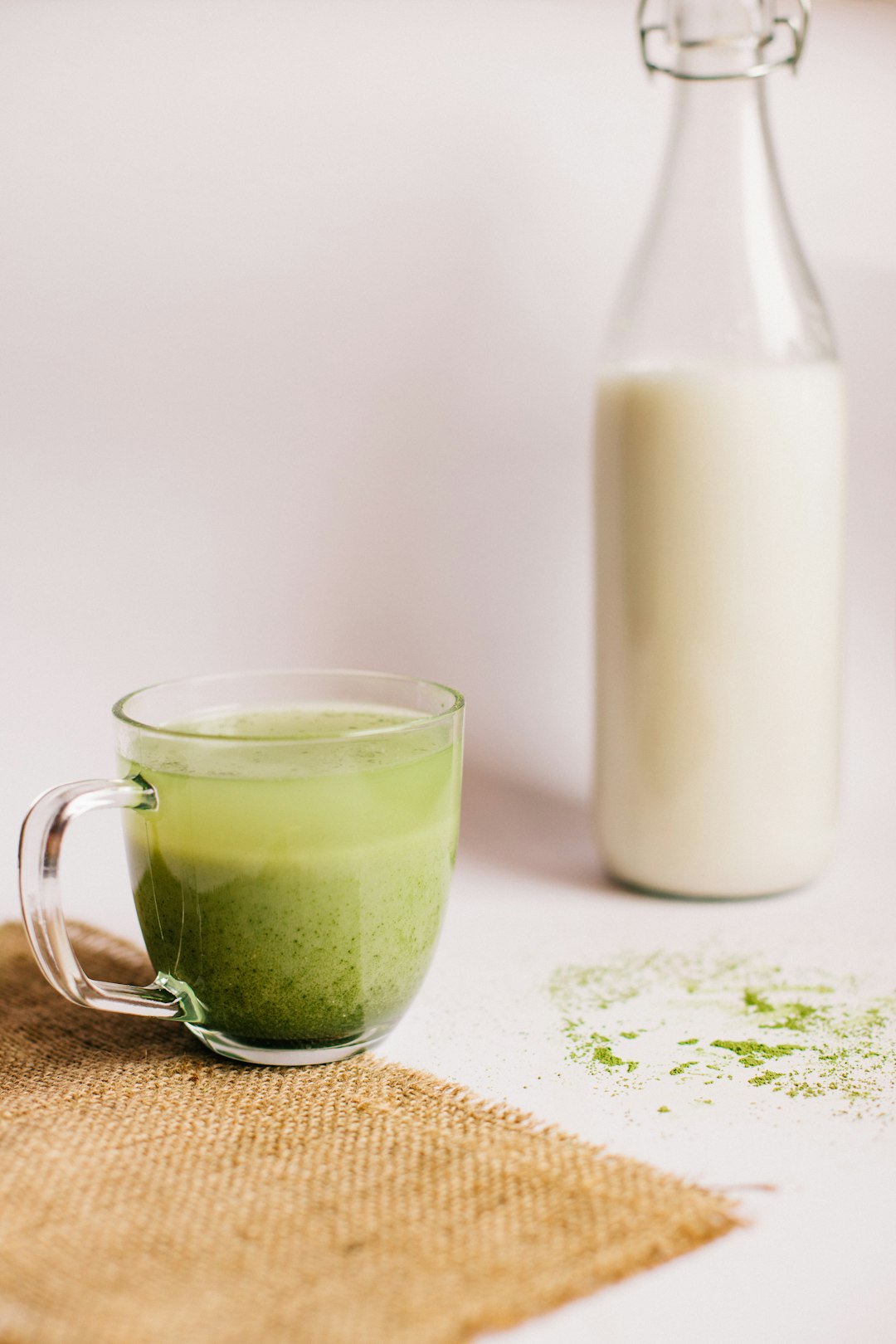 clear glass mug with green liquid