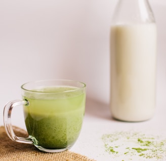 clear glass mug with green liquid