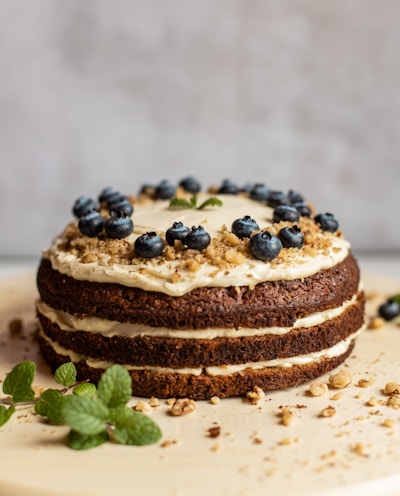 brown and black pastry with blue berries on white ceramic plate