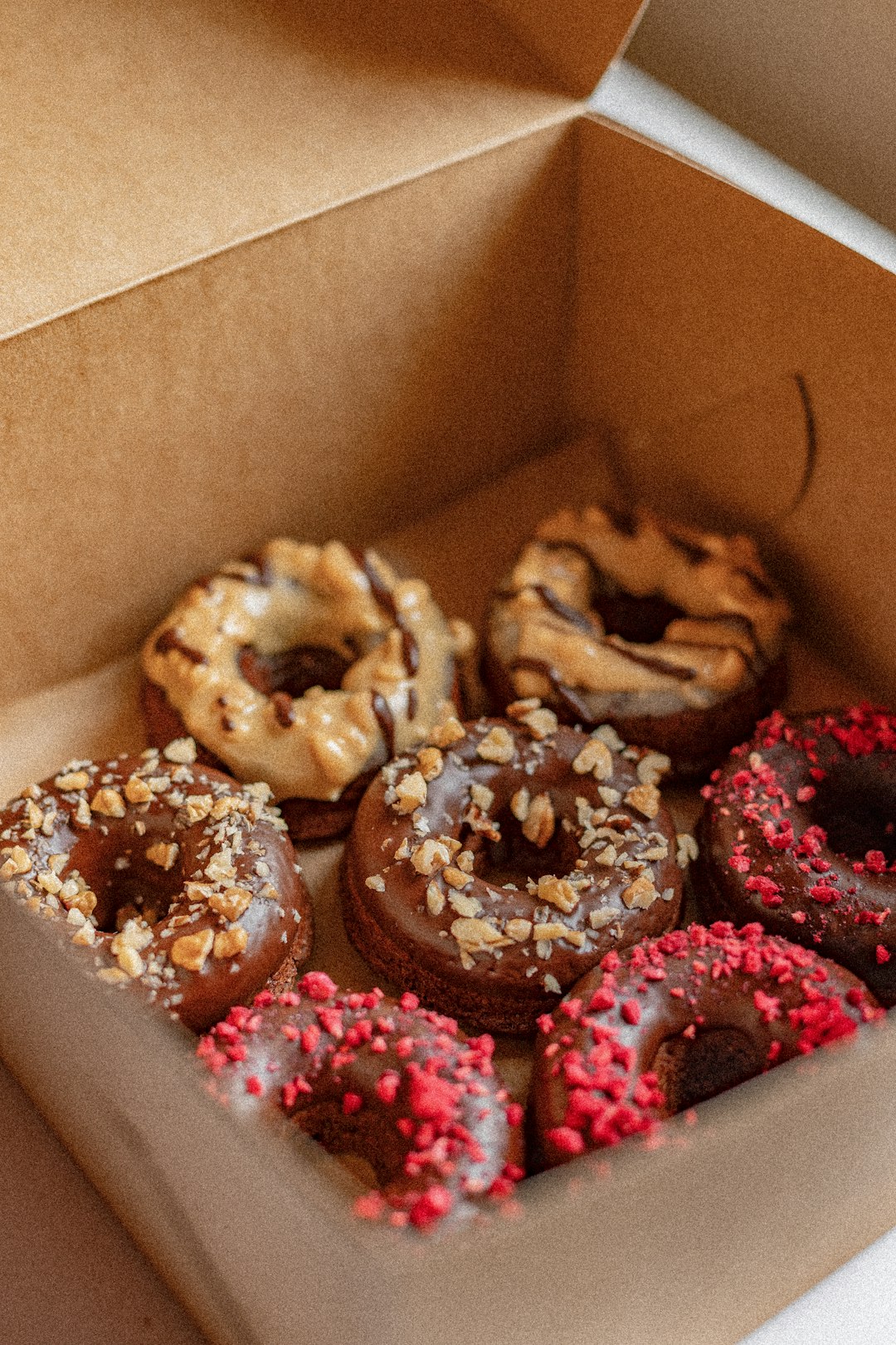 brown and pink donuts in box