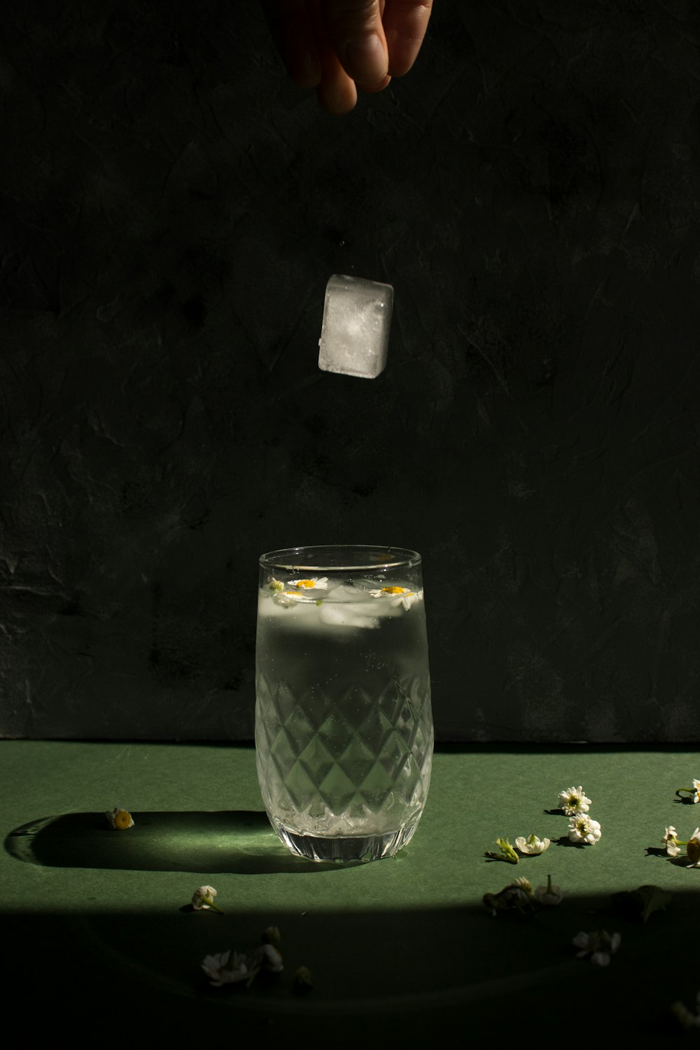 clear drinking glass on green table