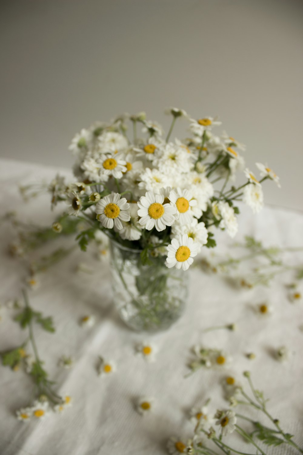 white flowers in clear glass vase