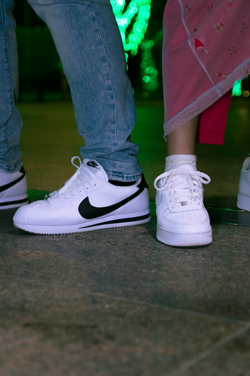 person wearing white and black nike sneakers