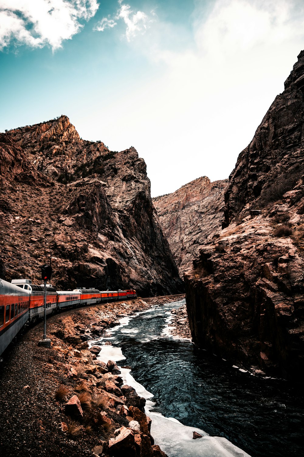 brown and white bridge near brown rock formation during daytime