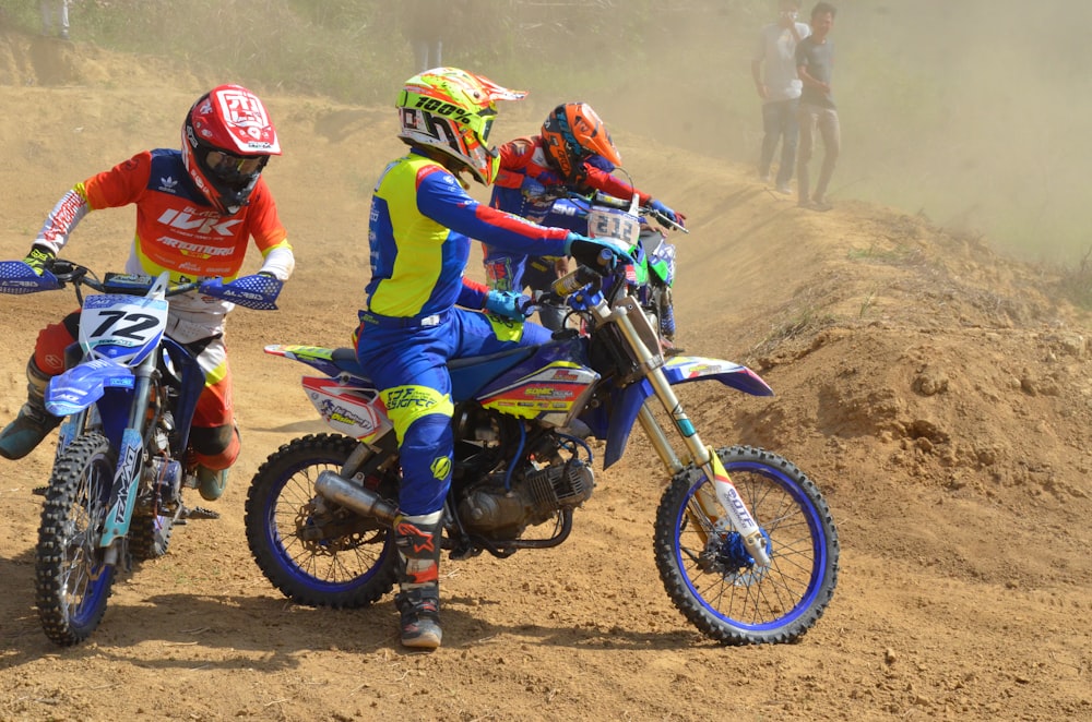 2 men riding motocross dirt bikes