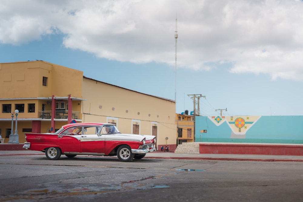 red and white sedan on road during daytime