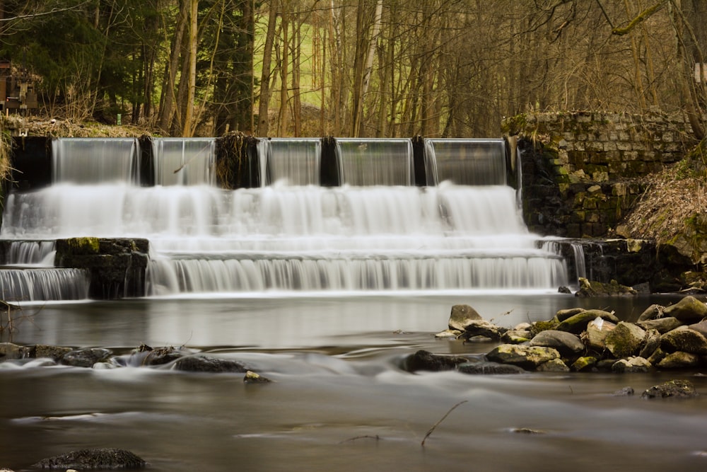 water falls in the middle of the woods