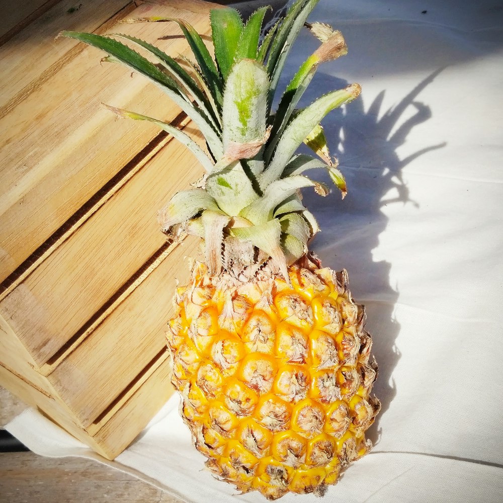 pineapple fruit on brown wooden table