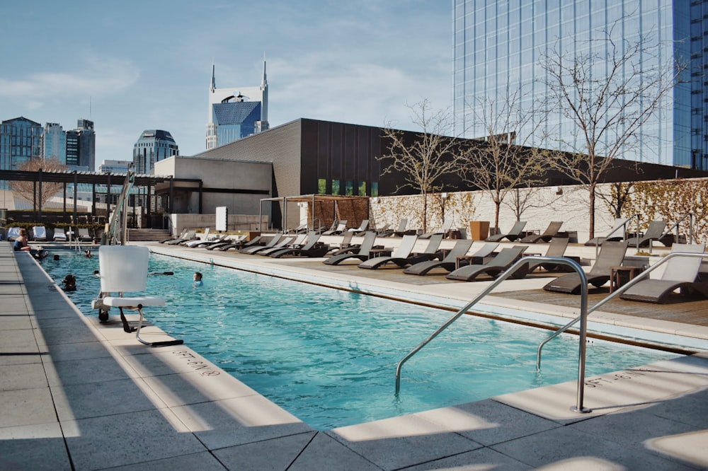 swimming pool near gray concrete building during daytime