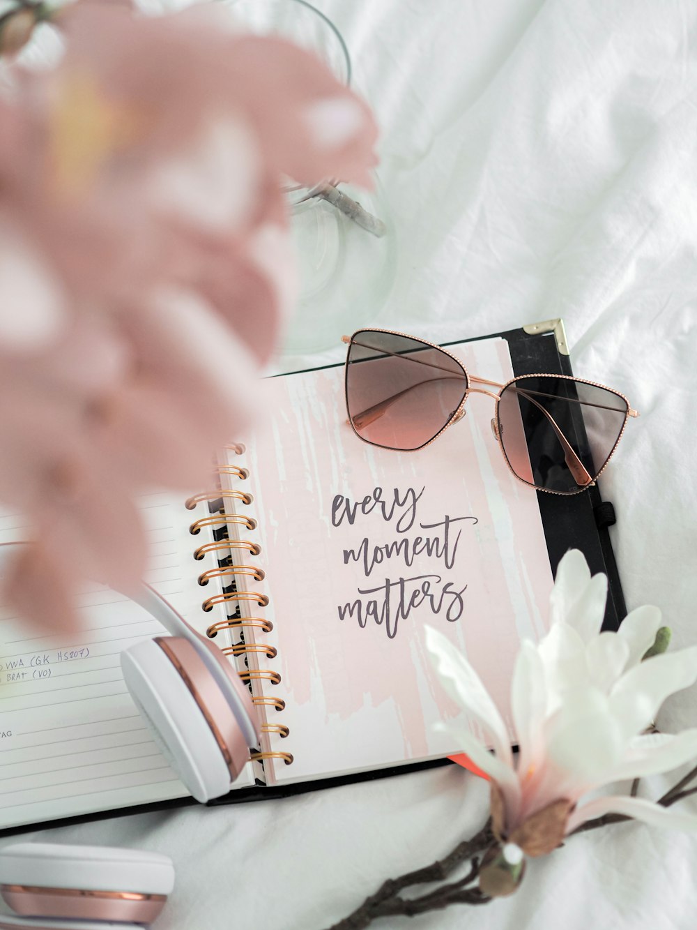 black framed eyeglasses on white notebook