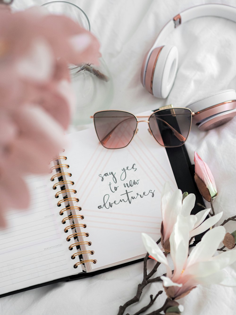 gold framed aviator style sunglasses on white ruled paper