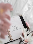 white and pink flower on white textile