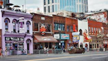 A vibrant street scene from New Orleans with colorful buildings and lively music.