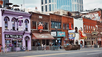 A vibrant street scene showing restored historic storefronts bustling with locals.