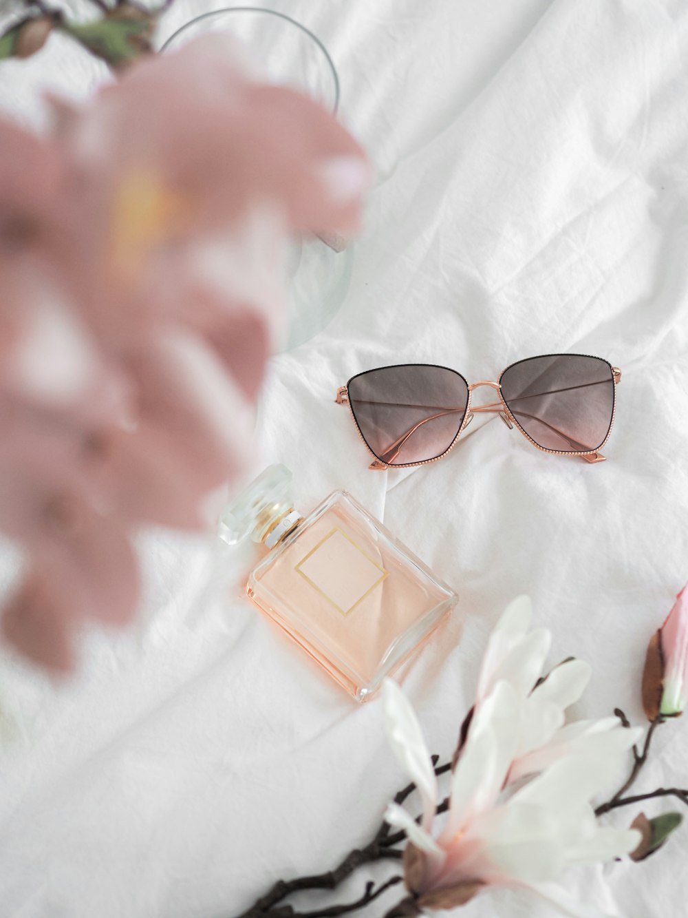 brown framed sunglasses on white and pink textile