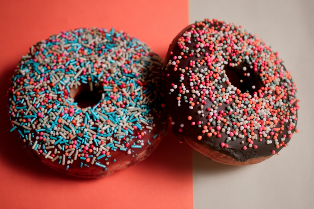2 rote und weiße geblümte Donuts