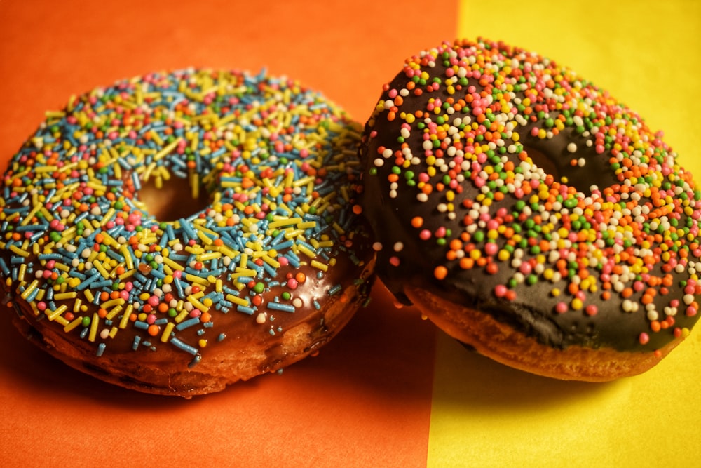 two doughnuts on brown wooden table