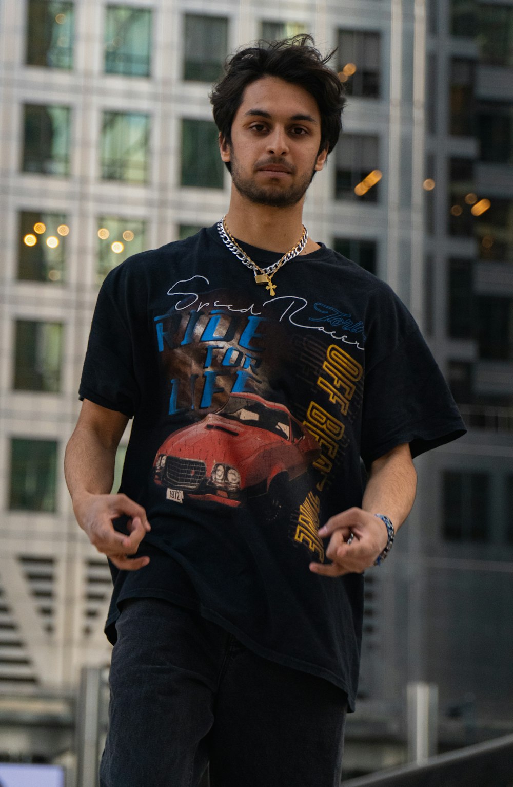 man in black crew neck t-shirt and black pants standing