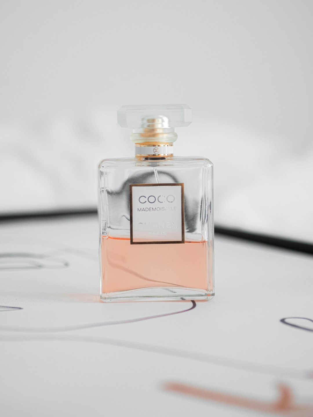 clear glass perfume bottle on white surface