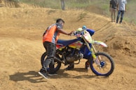 Tow truck driver assisting a motorcyclist beside a busy Ankara road.