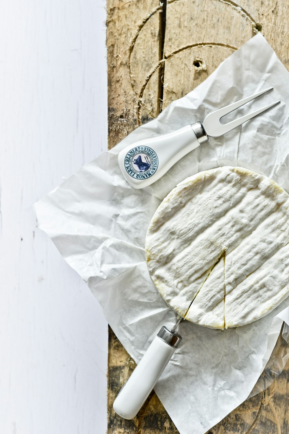 white and blue round container on white textile