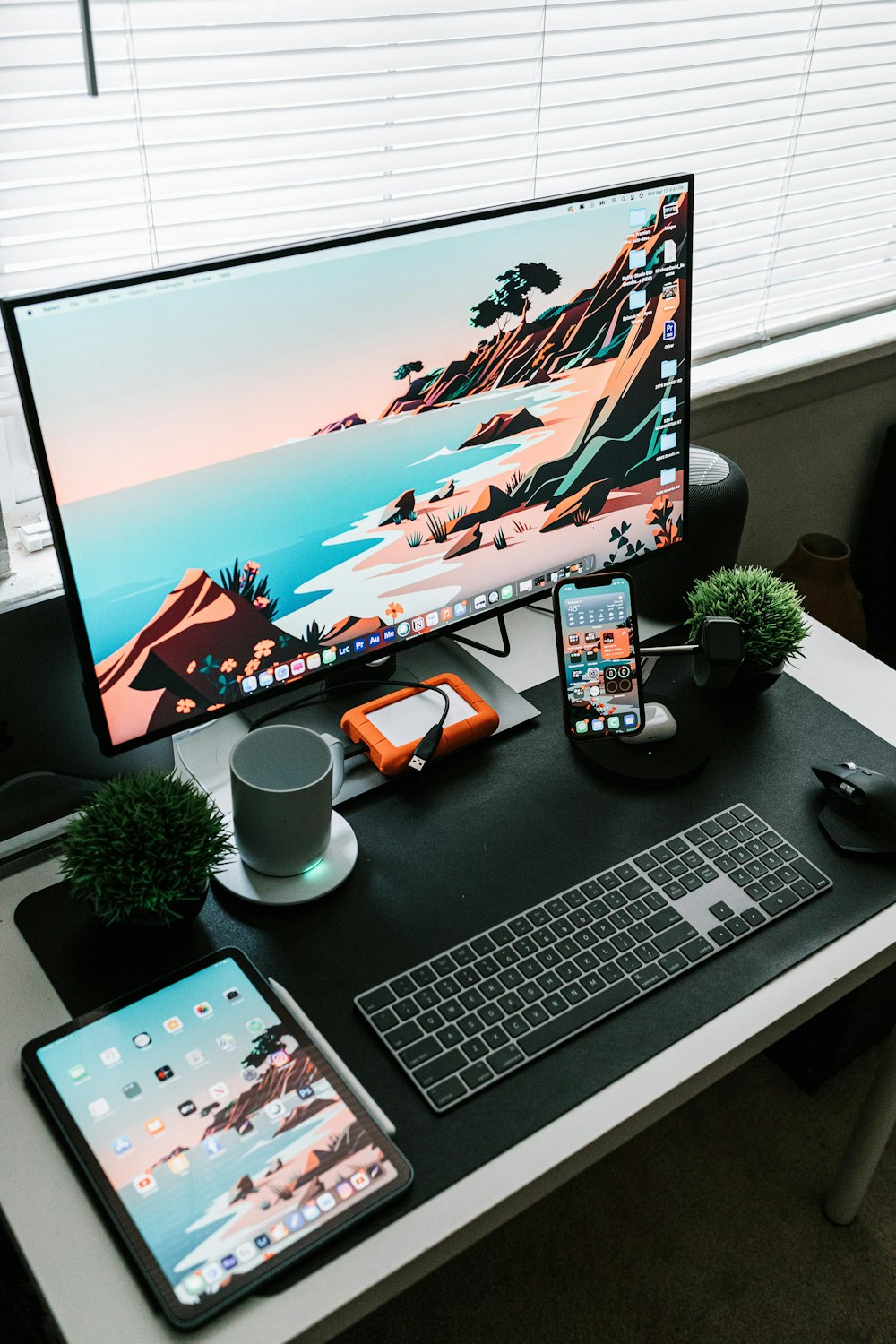 silver imac beside black remote control