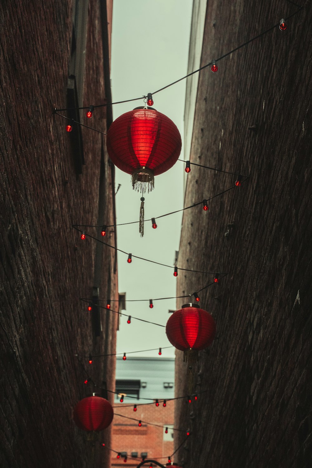 red paper lantern on gray wooden wall