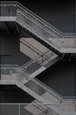 white metal staircase on gray concrete floor