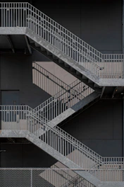 white metal staircase on gray concrete floor