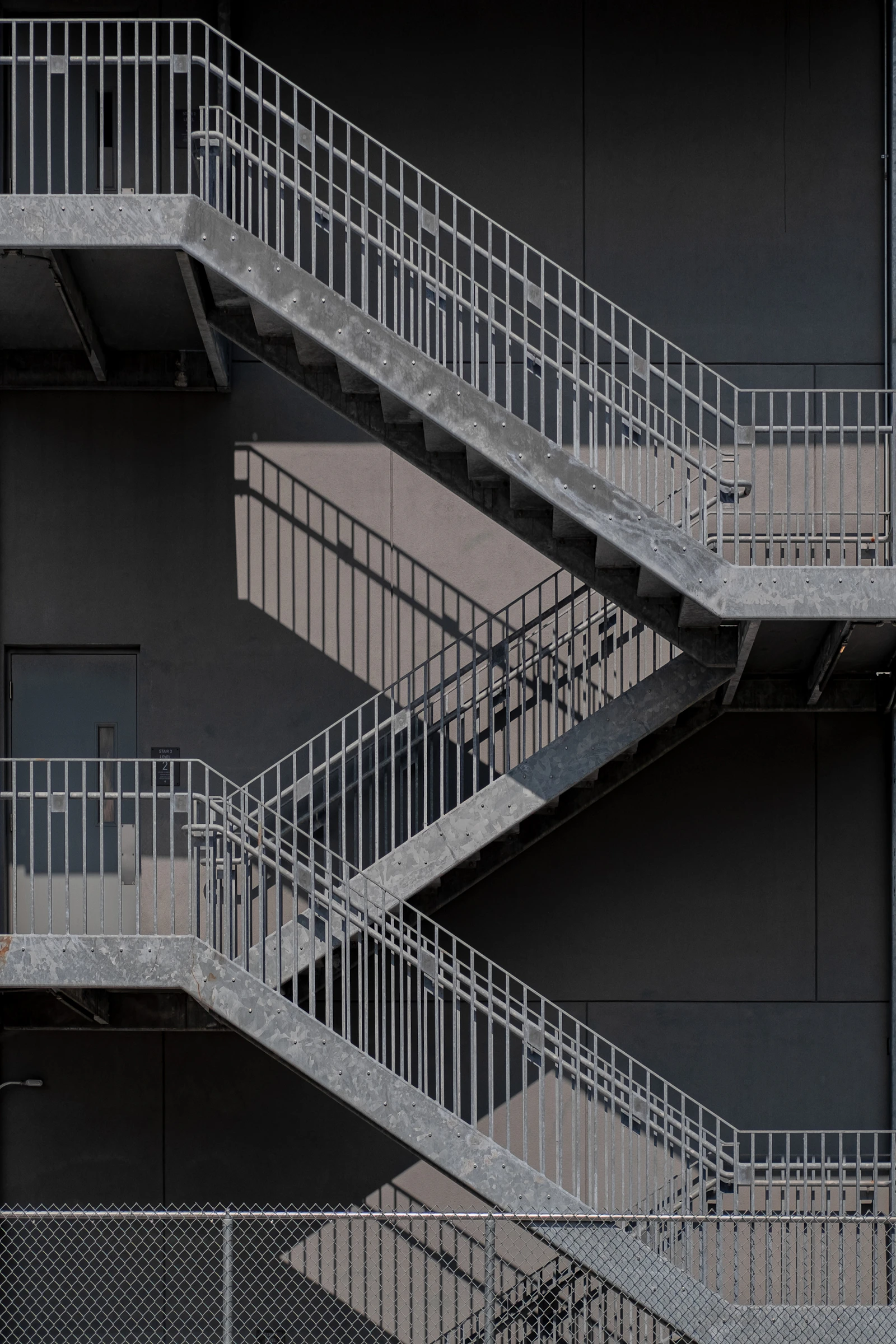White metal staircase on gray concrete floor