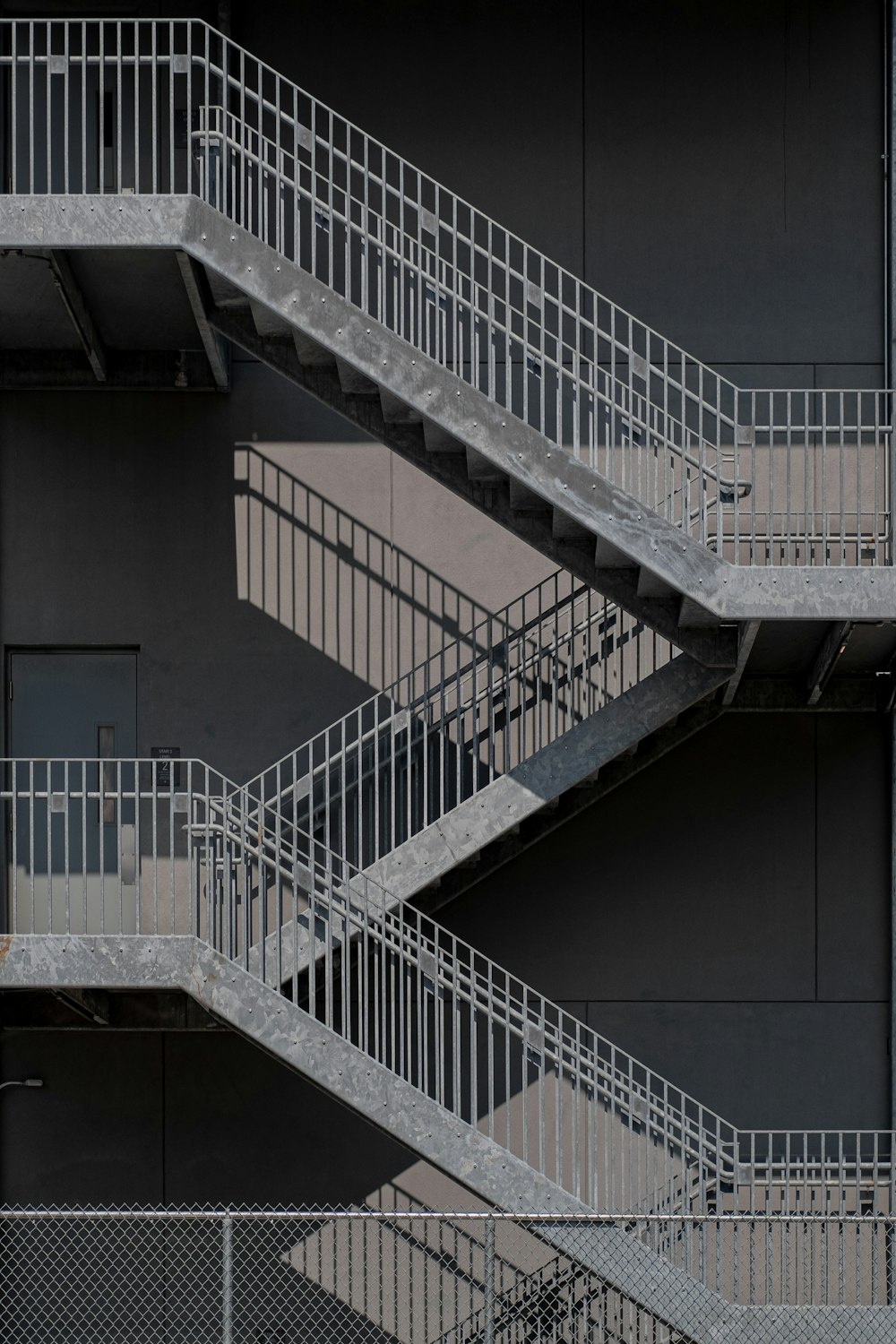 white metal staircase on gray concrete floor