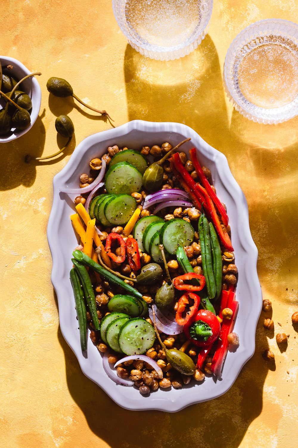 sliced cucumber and green chili on white ceramic bowl