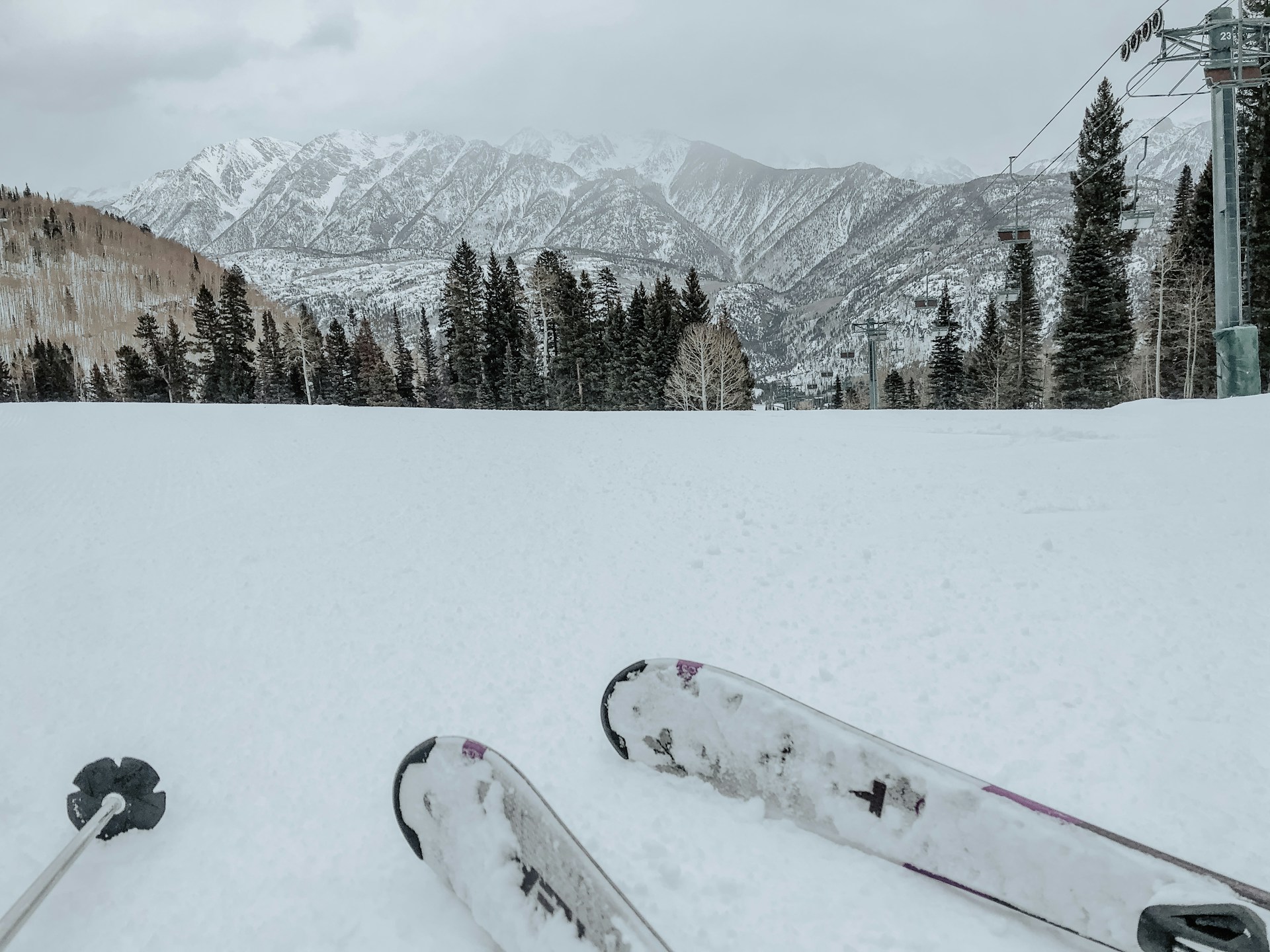 Person in red and white snow ski on snow covered ground