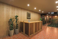 Reception desk adorned with fresh flowers and leafy plants creating a calm atmosphere.