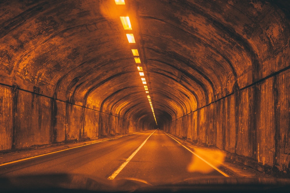 empty tunnel with lights turned on during night time