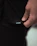 Close-up of a delicate, minimalist clothing tag with the Sutilia logo on soft fabric.