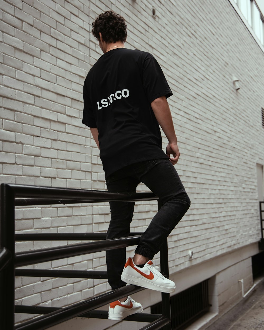 man in black and white adidas t-shirt and black pants wearing white nike  sneakers photo – Free Clothing Image on Unsplash