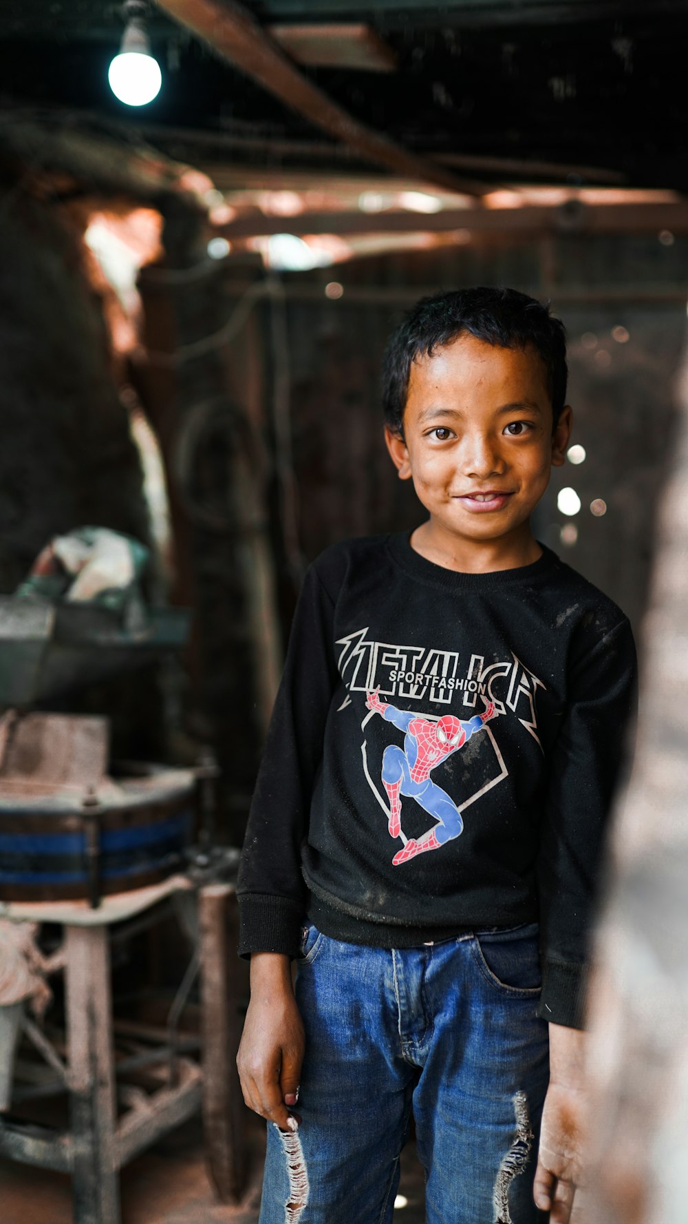 boy in black and white crew neck long sleeve shirt standing near brown wooden barrels