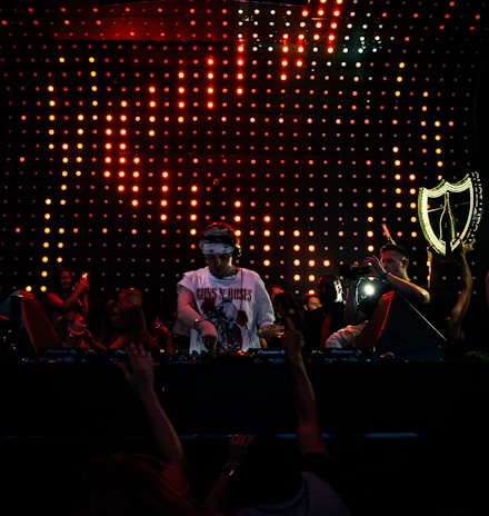 man in white shirt standing on stage