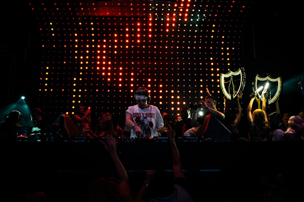 man in white shirt standing on stage